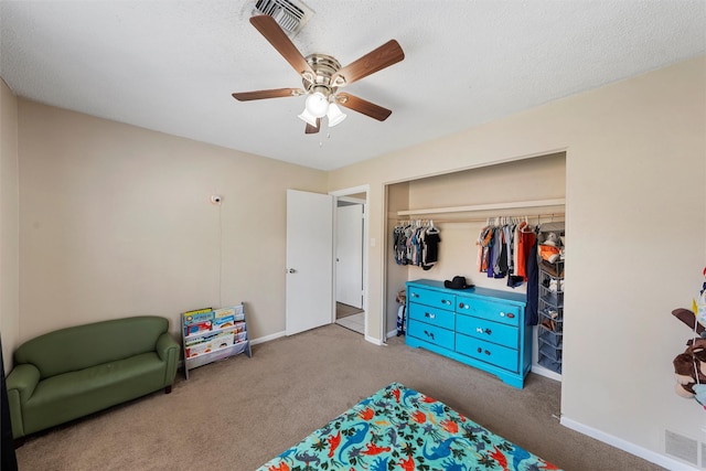 bedroom featuring visible vents, a ceiling fan, a closet, carpet flooring, and baseboards