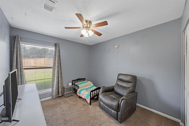 carpeted bedroom with visible vents, ceiling fan, a textured ceiling, and baseboards