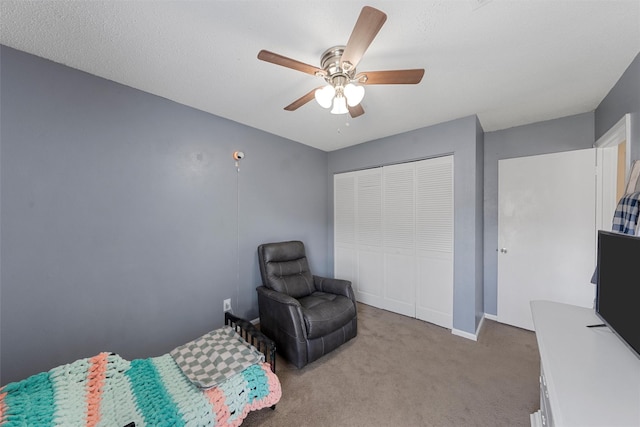 bedroom featuring a closet, ceiling fan, baseboards, and carpet