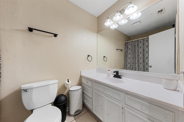 bathroom featuring tile patterned flooring, visible vents, toilet, and vanity