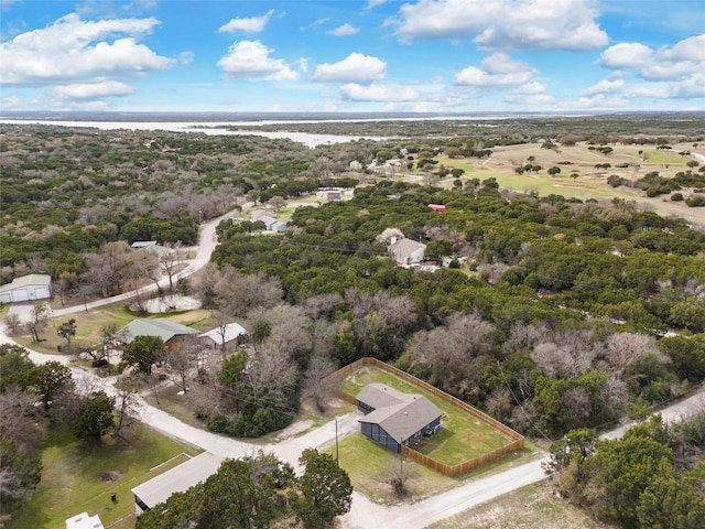 drone / aerial view with a wooded view