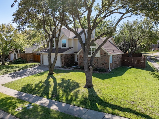 traditional home with a front yard, fence, concrete driveway, a garage, and brick siding