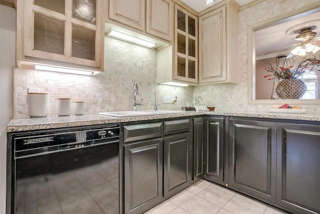 kitchen with ornamental molding, a sink, backsplash, light tile patterned floors, and dishwasher