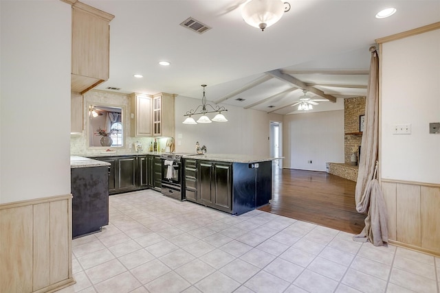 kitchen featuring visible vents, a peninsula, vaulted ceiling with beams, black range with electric cooktop, and wainscoting