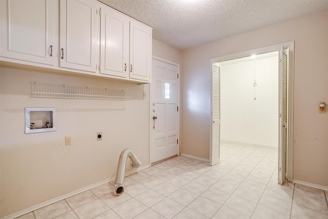 laundry room featuring baseboards, hookup for a washing machine, cabinet space, electric dryer hookup, and a textured ceiling