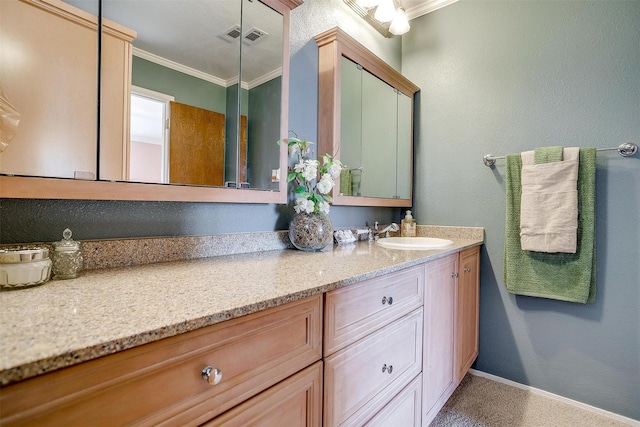 bathroom featuring vanity, crown molding, visible vents, and baseboards