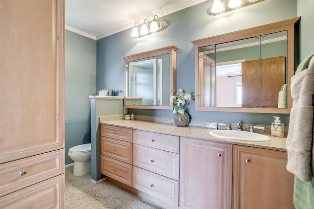 bathroom with vanity, crown molding, and toilet