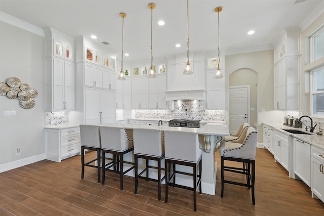 kitchen with range, dark wood-type flooring, white cabinets, and custom range hood