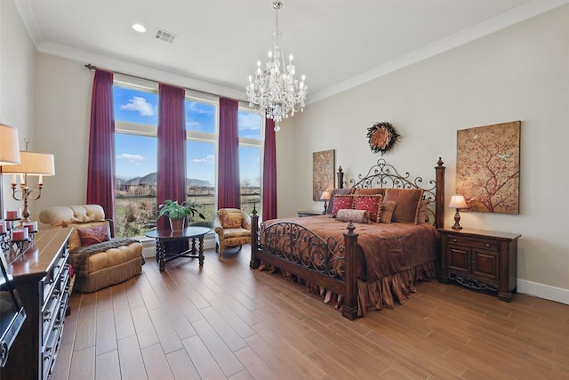 bedroom with visible vents, crown molding, an inviting chandelier, and wood finished floors