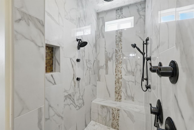 bathroom featuring a wealth of natural light and a marble finish shower