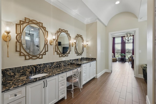 bathroom with wood finished floors, baseboards, and a sink