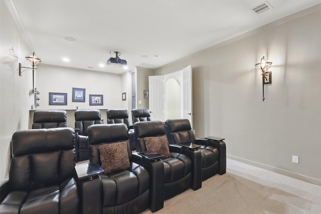 carpeted home theater featuring visible vents, recessed lighting, baseboards, and ornamental molding