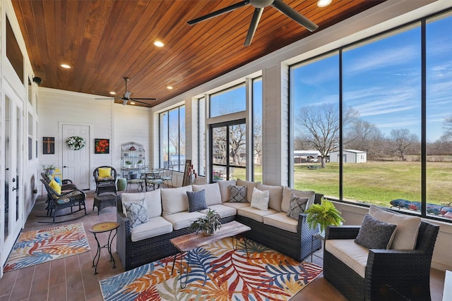 sunroom / solarium featuring wooden ceiling and ceiling fan