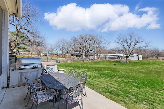 view of patio / terrace with outdoor dining space, a grill, and fence