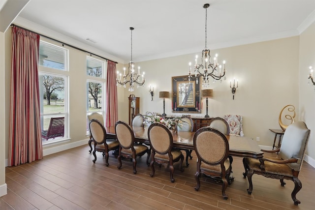 dining room with a notable chandelier, wood finished floors, and crown molding