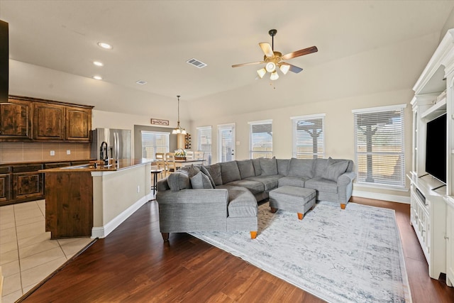 living room featuring a ceiling fan, visible vents, baseboards, recessed lighting, and dark wood-type flooring