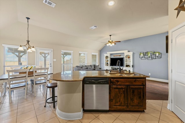 kitchen featuring vaulted ceiling, visible vents, dishwasher, and a sink