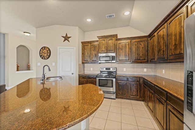 kitchen featuring light tile patterned floors, visible vents, a sink, decorative backsplash, and appliances with stainless steel finishes