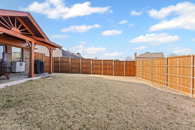 view of yard featuring a patio area and a fenced backyard