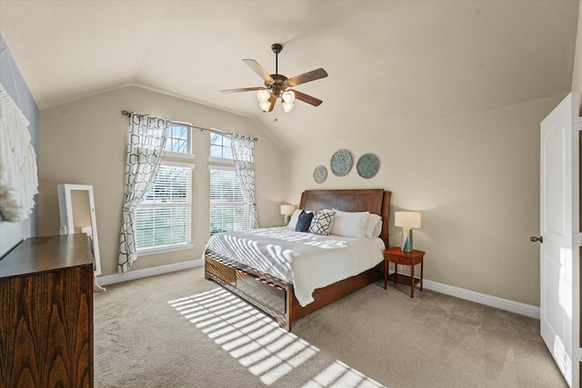 carpeted bedroom with ceiling fan, baseboards, and lofted ceiling