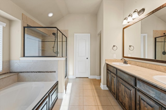 full bathroom featuring tile patterned floors, vaulted ceiling, a stall shower, and a sink