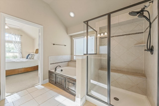 bathroom with lofted ceiling, tile patterned flooring, a shower stall, ensuite bathroom, and a bath