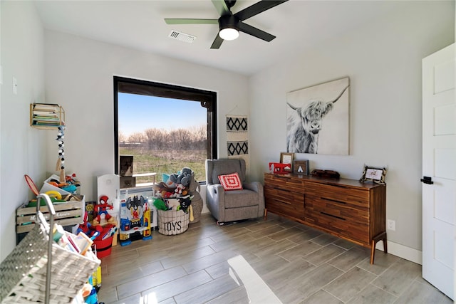 interior space featuring visible vents, wood finish floors, and a ceiling fan