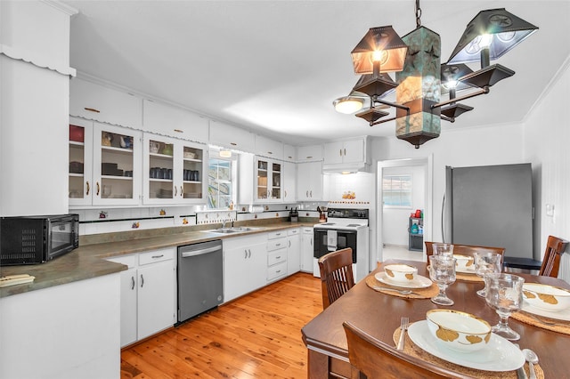 kitchen with a wealth of natural light, light wood-style flooring, a sink, white cabinetry, and appliances with stainless steel finishes