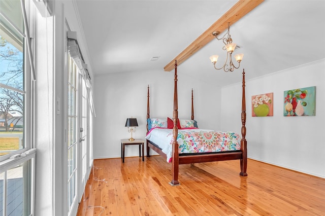 bedroom with light wood finished floors, a notable chandelier, and lofted ceiling with beams