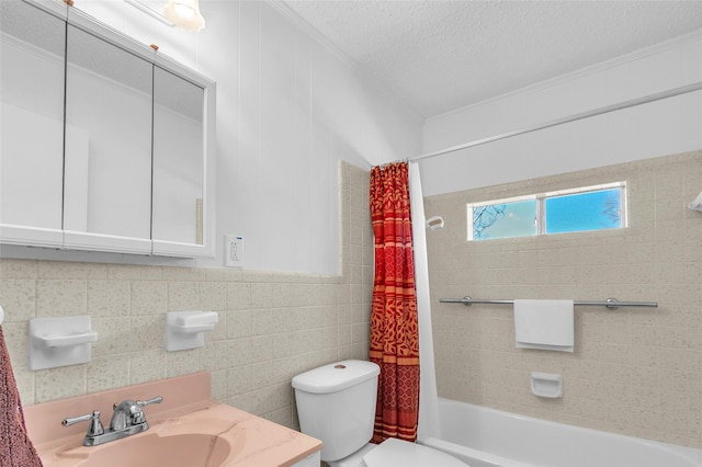 full bathroom featuring vanity, shower / bath combo with shower curtain, a textured ceiling, tile walls, and toilet