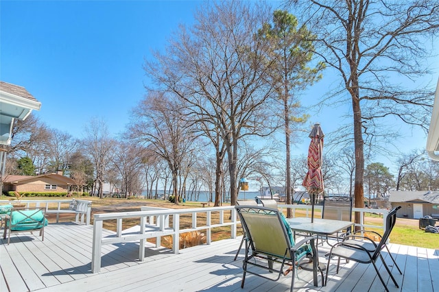 wooden terrace featuring outdoor dining space