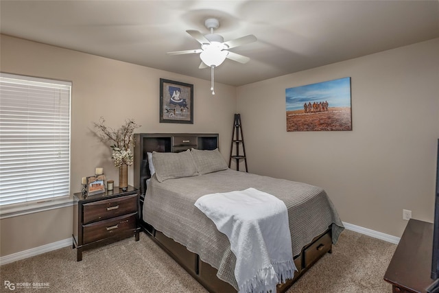 bedroom with a ceiling fan, light colored carpet, and baseboards