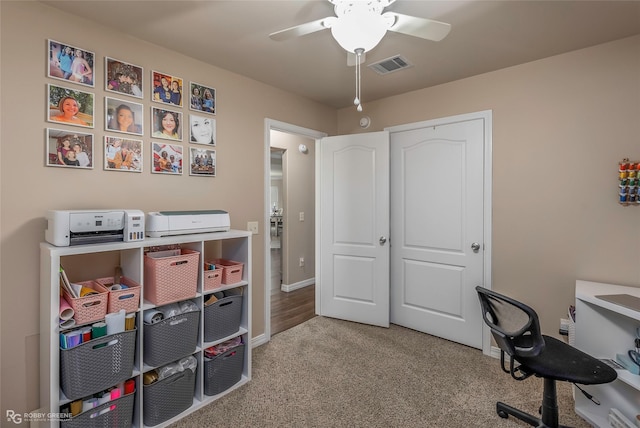 office featuring visible vents, baseboards, carpet flooring, and a ceiling fan