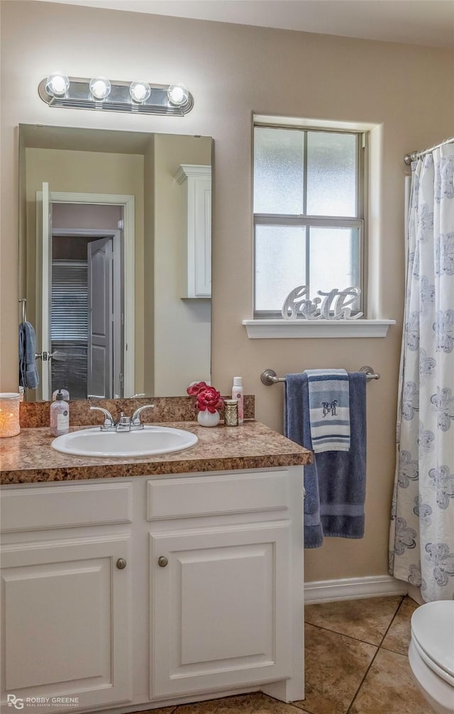 full bathroom featuring vanity, tile patterned floors, and toilet