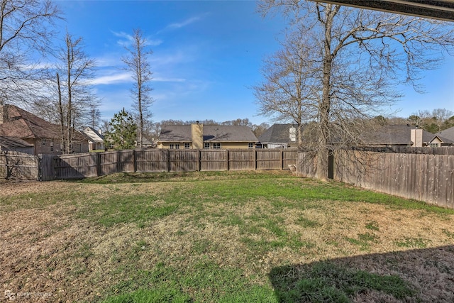 view of yard featuring a residential view and a fenced backyard