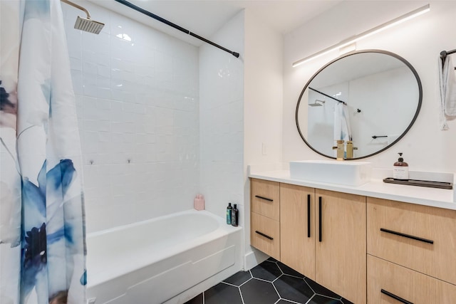 full bath featuring tile patterned floors, shower / bath combination with curtain, and vanity