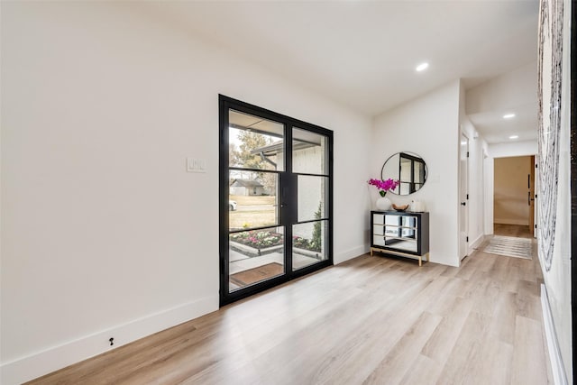 interior space with recessed lighting, baseboards, and light wood-style floors