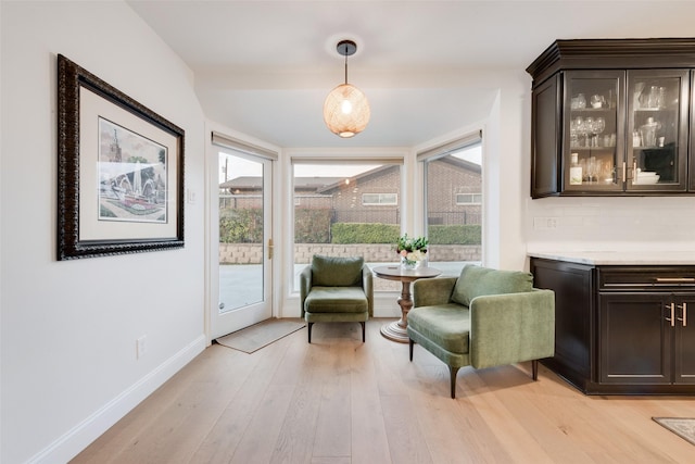 sitting room with light wood-style flooring and baseboards