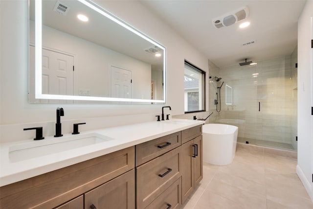 bathroom with visible vents, a shower stall, and a sink