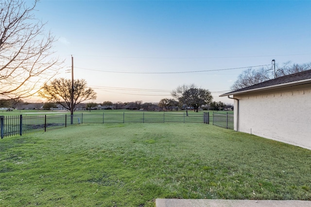 view of yard featuring a rural view and a fenced backyard