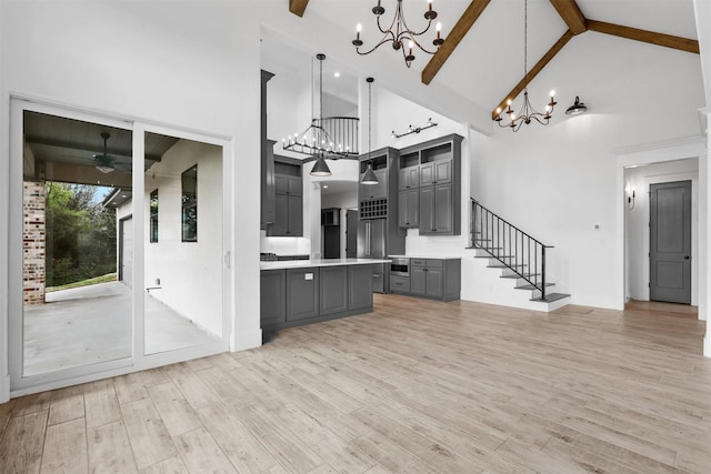 interior space featuring beam ceiling, light countertops, gray cabinets, and light wood-type flooring