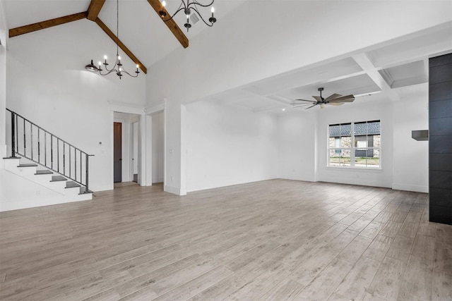 unfurnished living room with light wood finished floors, stairs, beam ceiling, ceiling fan with notable chandelier, and high vaulted ceiling