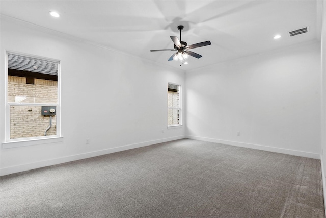 carpeted empty room with visible vents, ornamental molding, recessed lighting, baseboards, and ceiling fan