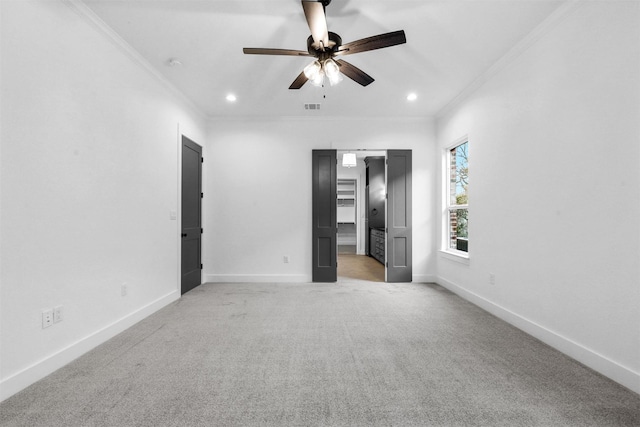 unfurnished bedroom featuring visible vents, recessed lighting, crown molding, baseboards, and light colored carpet