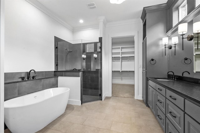 bathroom with vanity, visible vents, a stall shower, ornamental molding, and a walk in closet