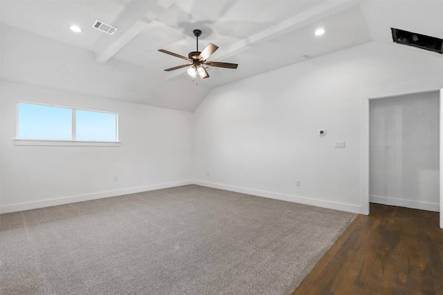 spare room featuring baseboards, visible vents, vaulted ceiling with beams, and ceiling fan