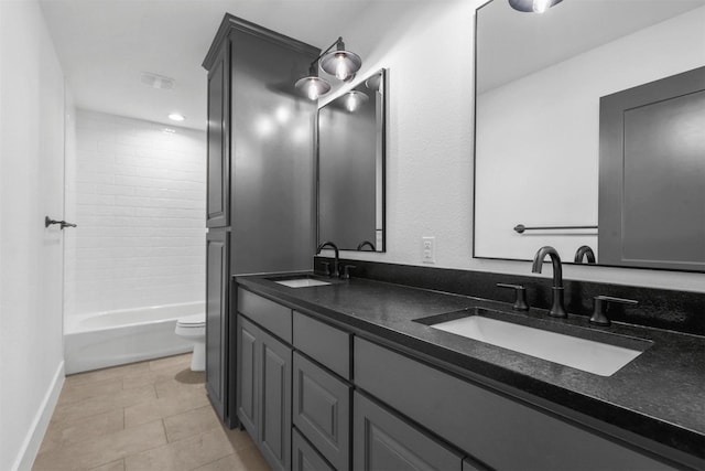 full bath featuring a sink, toilet, double vanity, and tile patterned flooring