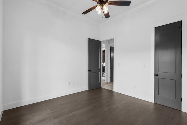 empty room with ornamental molding, baseboards, a ceiling fan, and wood finished floors