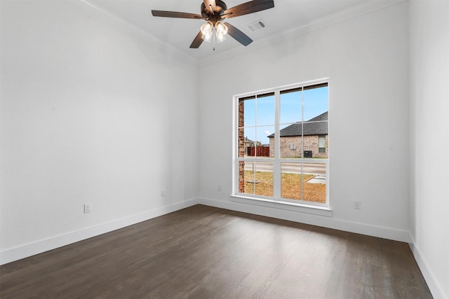 spare room with visible vents, baseboards, dark wood-style floors, and crown molding