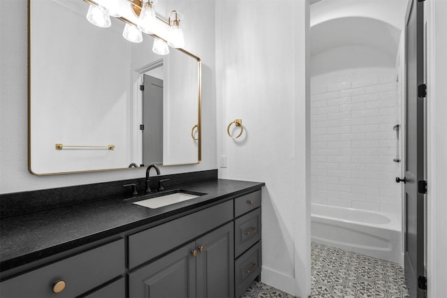 bathroom featuring tile patterned flooring, vanity, and bathing tub / shower combination